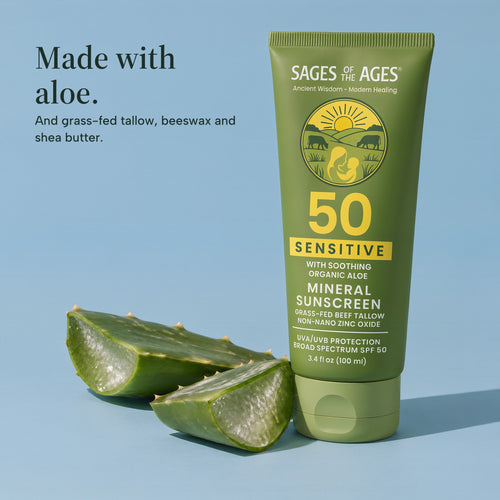 Tube of SPF 50 mineral sunscreen lotion beside two cut pieces of aloe leaf on a blue background. Made with aloe. And grass-fed tallow, beeswax and shea butter.